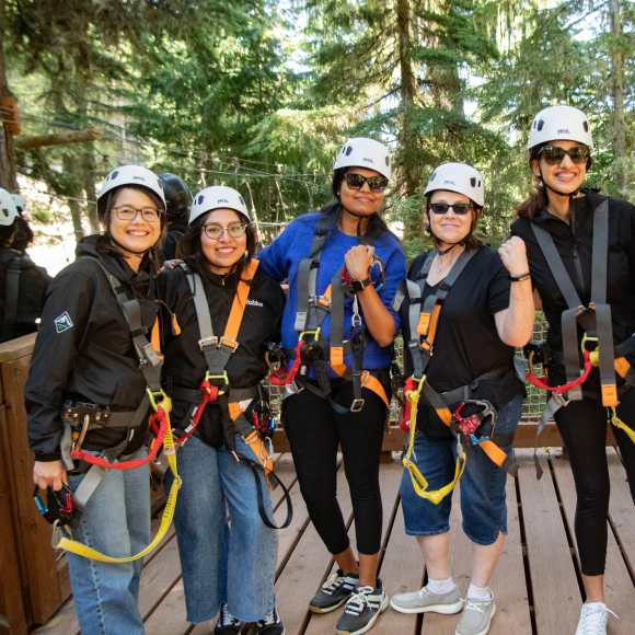 A group of teammates preparing for a ziplining activity